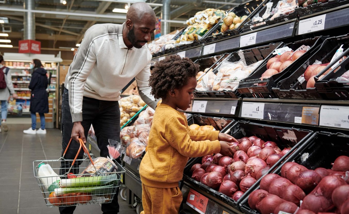 Child looking at onions with dad